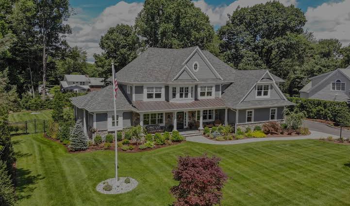 Estate home with manicured lawn and layered plantings